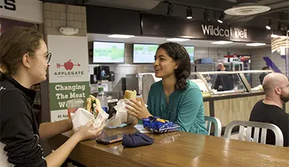 woman handing the food on campus