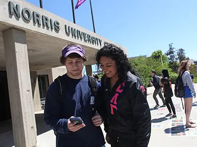 People chatting outside the Norris Center