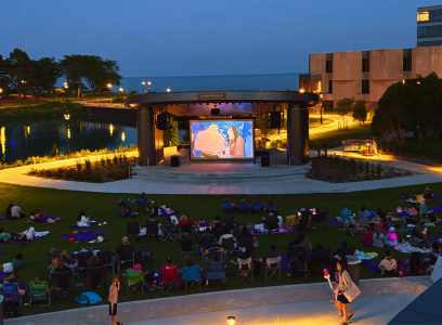 students watching movie on lawn