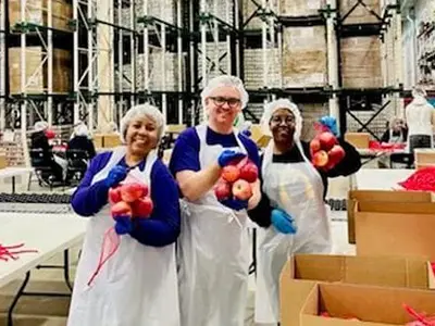 Volunteers holding apples