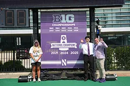 President Chiang assists the Northwestern Field Hockey Team in unveiling the 2025 National Championship banner ahead of their home opener.