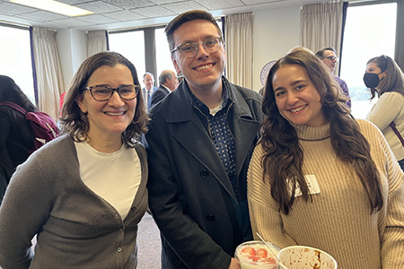 Three people smiling