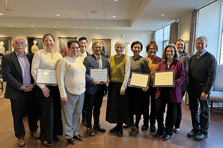 people holding award plaques