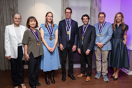 people smiling, showing off medals