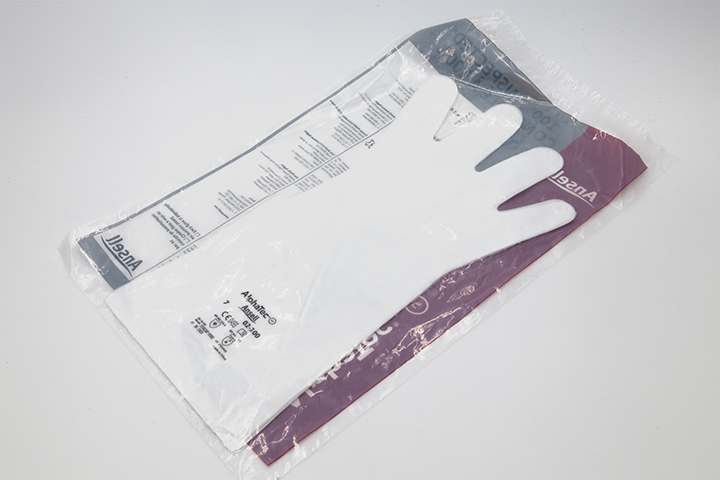 Plastic package with white gloves inside