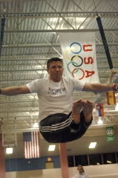 Gymnastics team founder Alex Lauder practices on the rings.