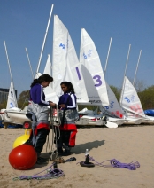 Sailing club members prepare for a home race