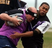 Craig Arrindell, right, a freshman rugby player, tackles an opponent from the Kellogg Rugby Football Club.