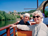 Jean Woolverton Yale, left, and Gwyn Davies Rahr (SESP57) cruise on the Dordogne River toward Beynac Castle.