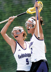 Aly Josephs (No. 5) and Sarah Albrecht celebrate the Wildcats