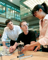 Thomas Perez (McC06), mechanical engineering senior Nicholas Graham and Josephine Yang (McC06) work on the prototype for the Finger Trainer (below), an Institute for Design Engineering and Applications creation to help stroke survivors redevelop typing, writing and sewing skills.