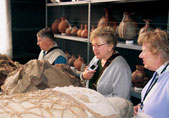 Northwestern travelers look over the "mummy bundles" in the laboratory of Guillermo Cock. The remains were excavated from a burial site in Puruchuco, east of Lima.