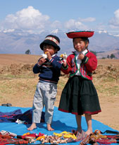 Peruvian children sell souvenirs on the roadside.