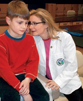 Medical student Traci Carroll examines her son Lucas