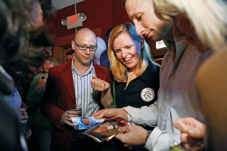 Classmates share family photos at the 15th party.
