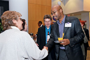 Larry Irving (WCAS76) greets a classmate at the 30th-reunion party.