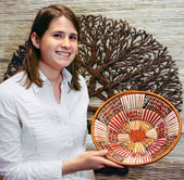 Lauren Parnell shows off a basket woven by Uganda Crafts artisans.