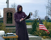 Sarah Maxwell reads the names of fallen U.S. troops at Memorial Park in Archbold, Ohio.