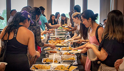 students getting food at an event