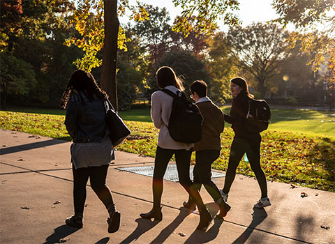 students walking through campus on a fall day