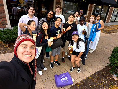 A group of students pose outdoors for a selfie