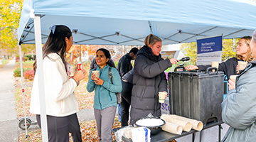 Students at a hot chocolate event off campus