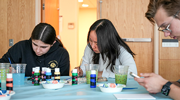 students painting at an area event