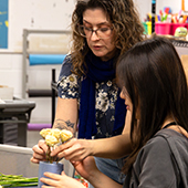 a student arranges a bouquet during a class
