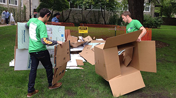 students breaking down cardboard boxes