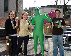 students with man in a green suit on earth day