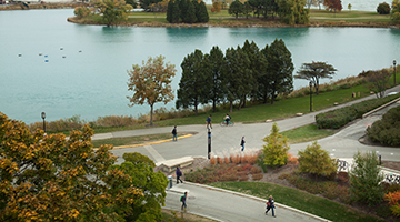 Ariel shot of the lakefill on campus with students biking and walking.