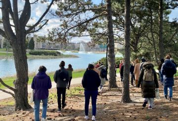 Students walking amongst pine trees on Northwestern campus