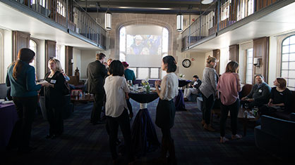 a group of people talking to each other at an event