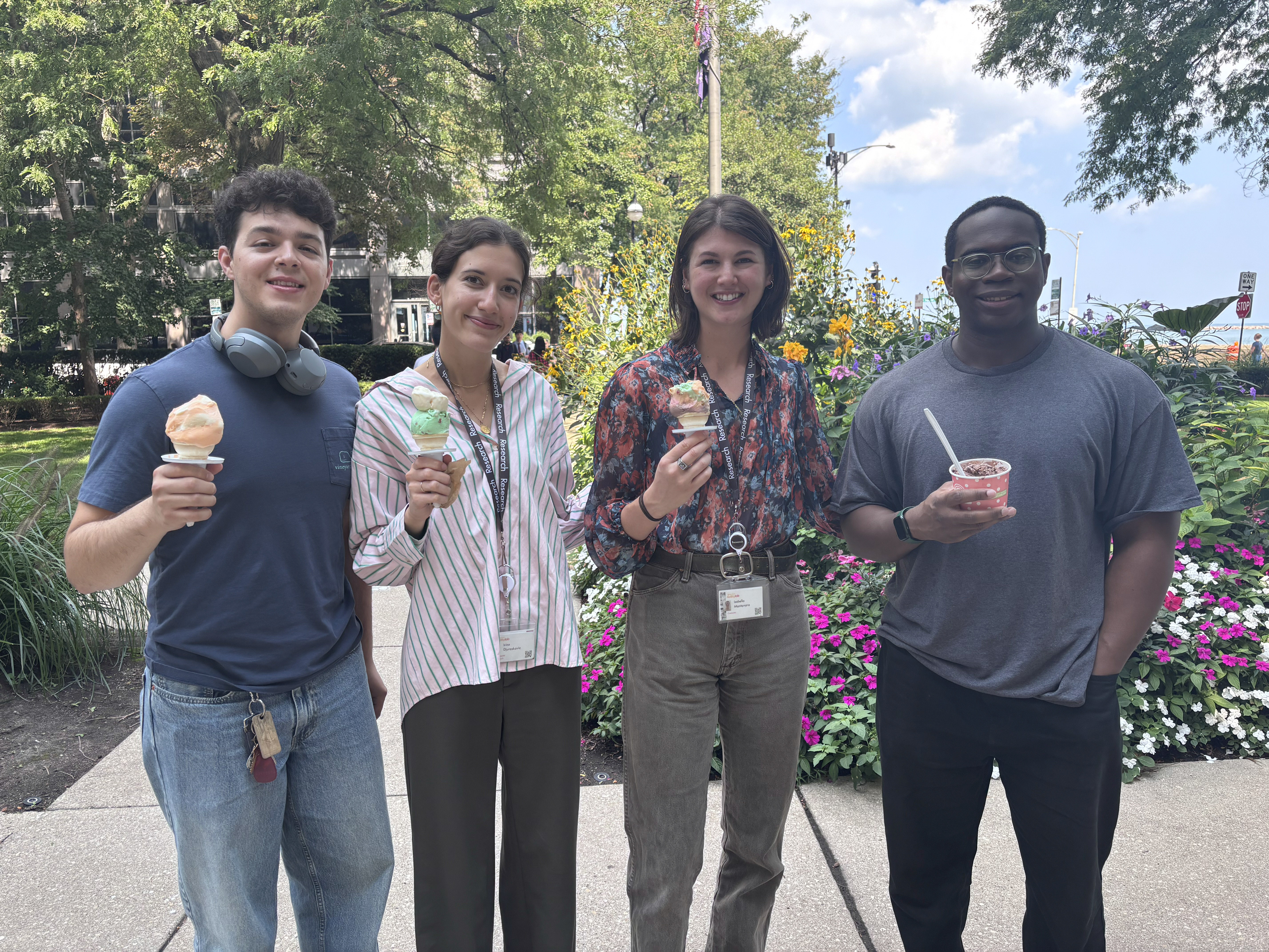 A group of students holding ice cream cups and cones outside