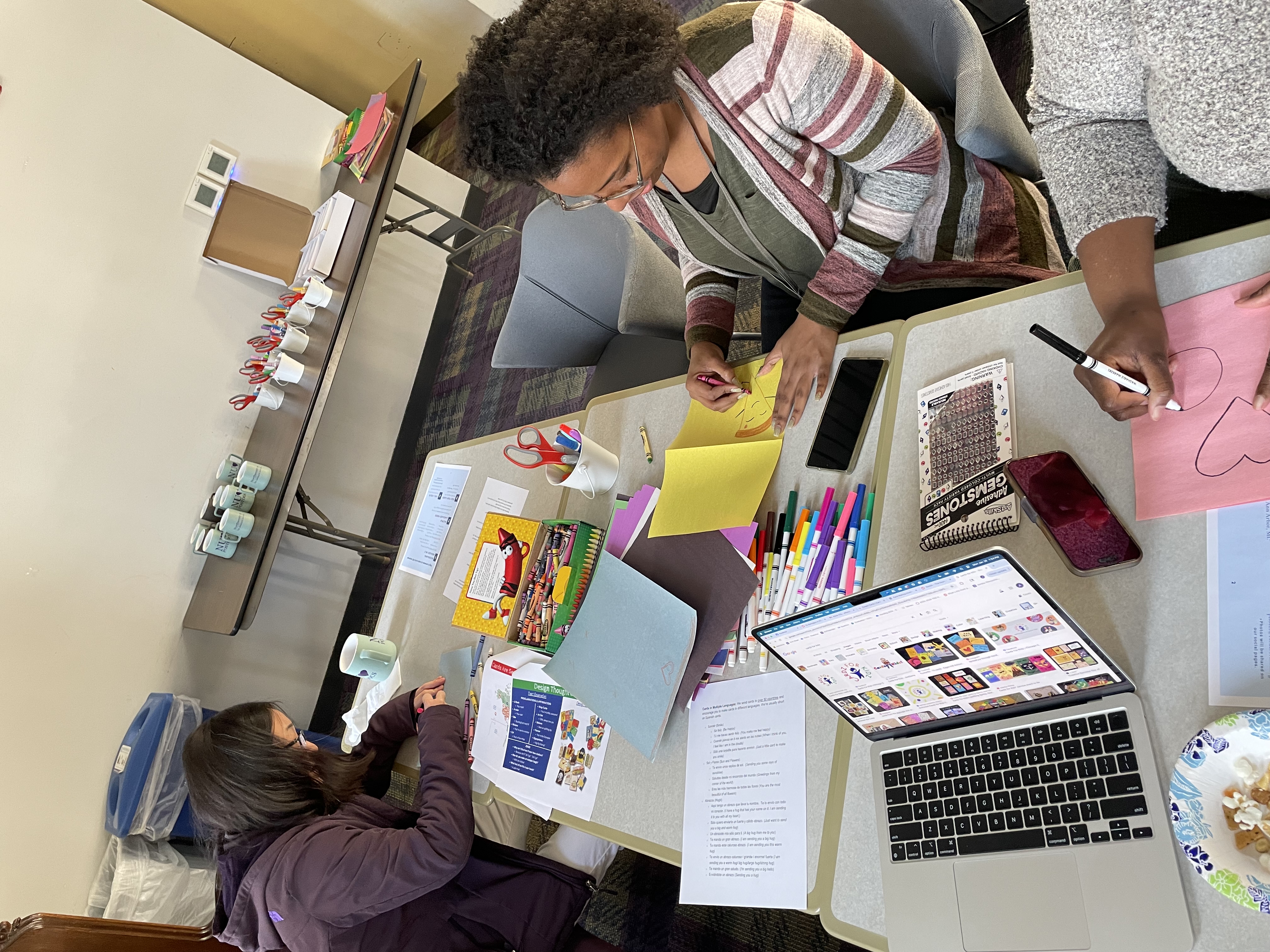 Students drawing and decorating greeting cards