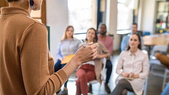 Woman giving a speech to the auditorium