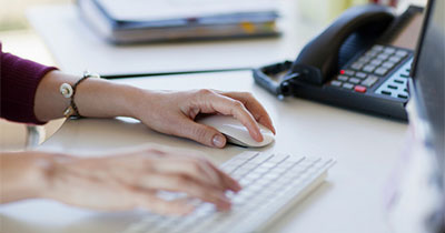 Hands typing on a keyboard