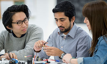 engineering students talking with instructor